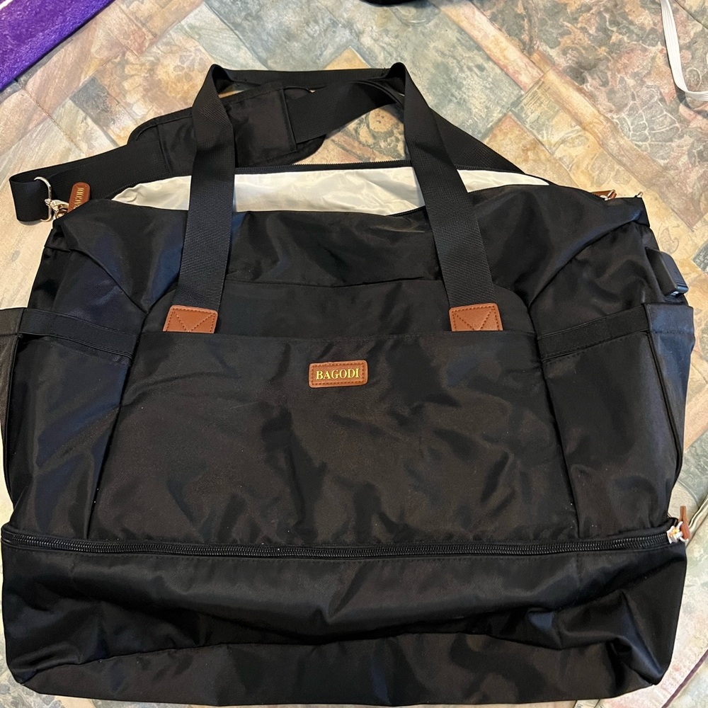 Black Duffel Bag with Leather Accents and Adjustable Strap